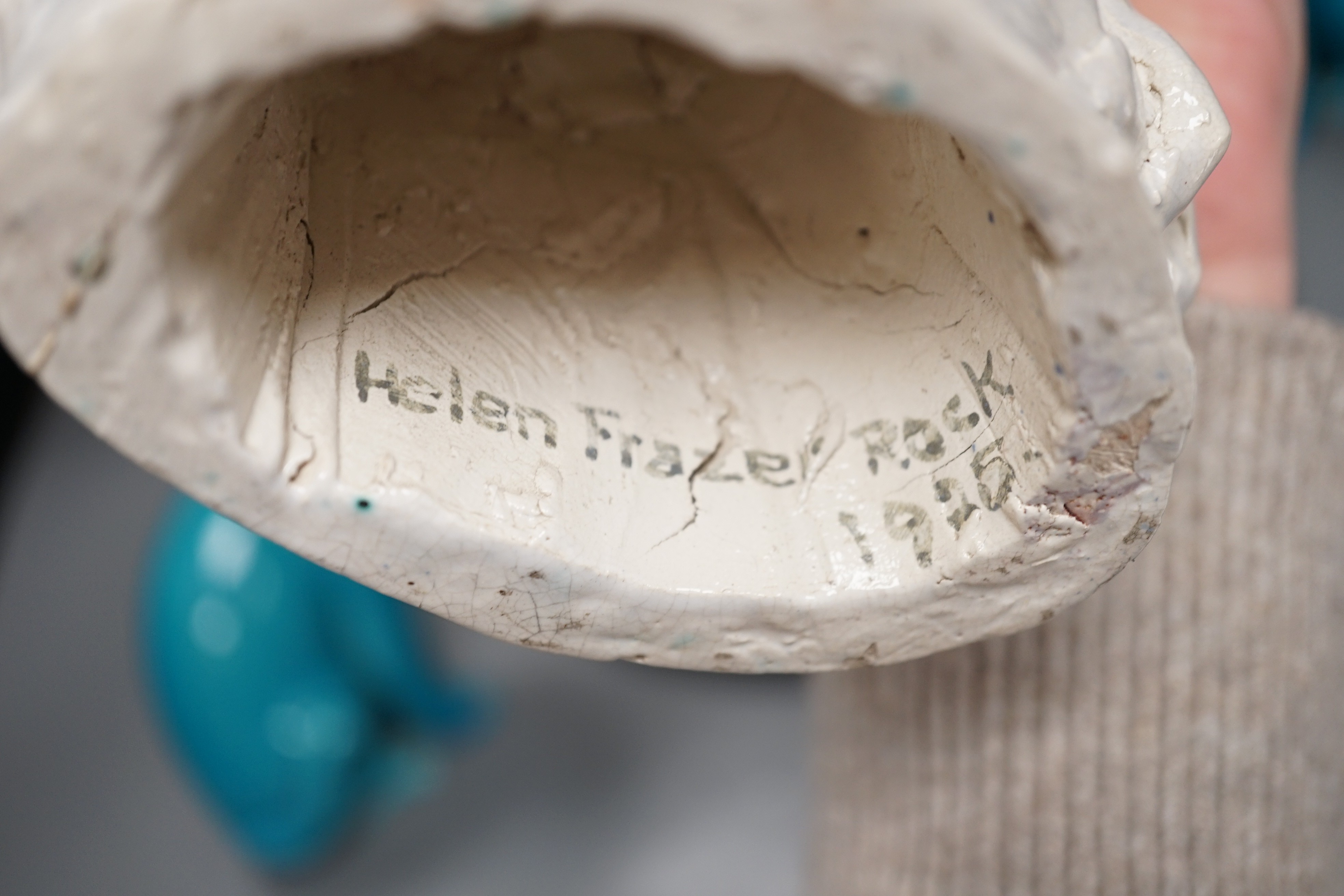 A selection of ceramics, to include two Vallauris plates, a bust of Madonna and child signed ‘Helen Fraser Rock 1925’, a Dutch figure and a pair of turquoise glazed cats etc.